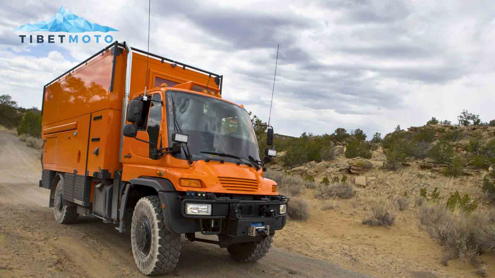 Orange expedition vehicle on its way to Asia