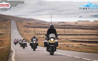 Motorcyclists ride one behind the other