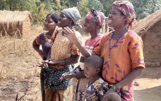 Locals watch the motorcyclists in Africa